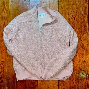 A pink fuzzy quarter zip from Top Shop. It is a size 4. Very comfortable to wear